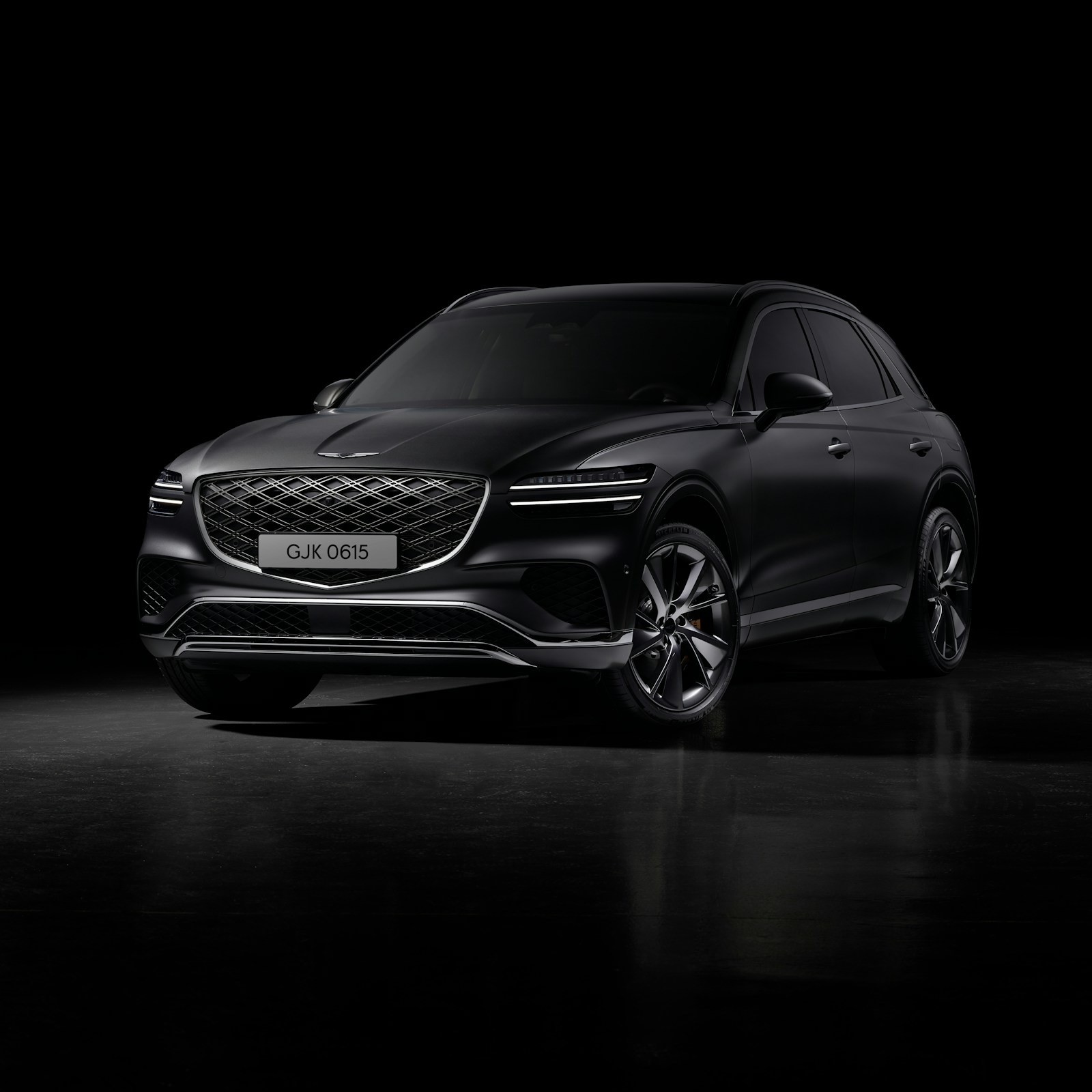 Black luxury SUV under studio light with a deep gloss finish